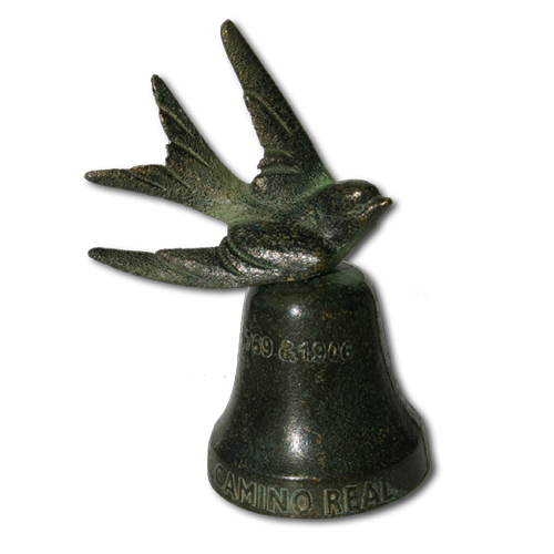 A brass swallow mounted to the top of a 2
